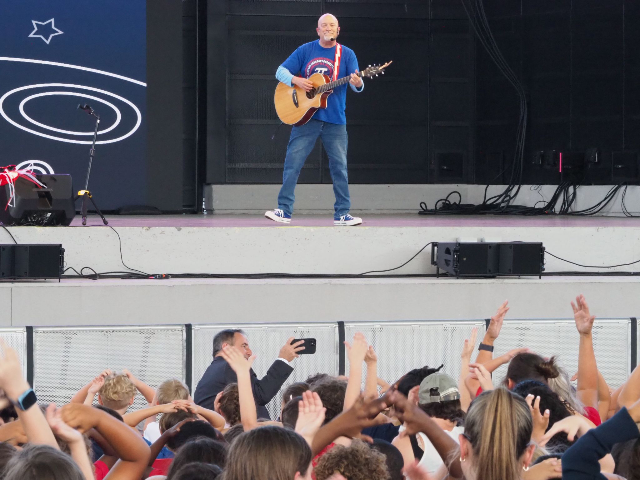 Roger Day performing on stage at The BayCare Sound in Downtown Clearwater to school children